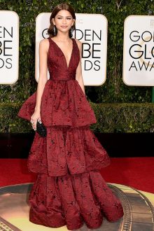 zendaya stuns at 2016 golden globes in plunging oxblood deep red prom celebrity red carpet gown